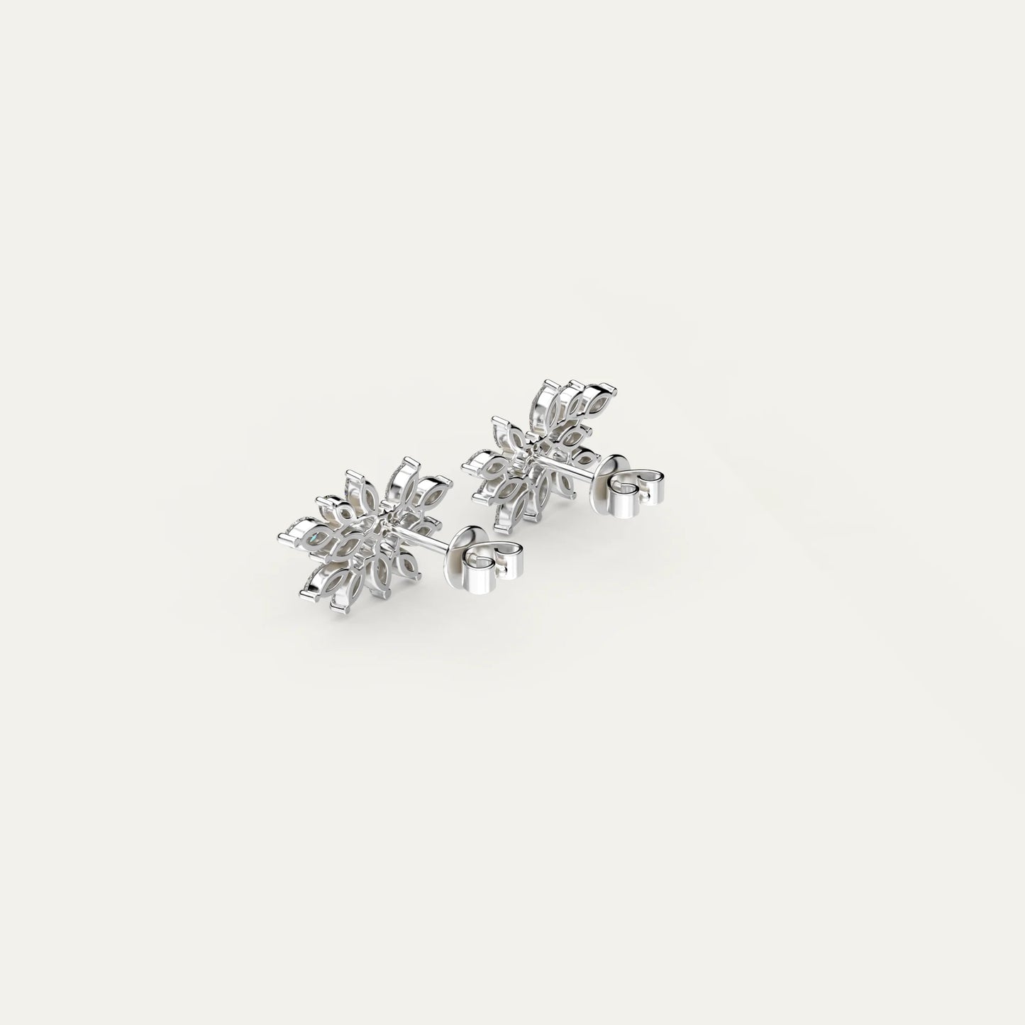 Close-up on Fleur Spark earrings by Goldmacher – floral-shaped sterling silver studs with zircons.