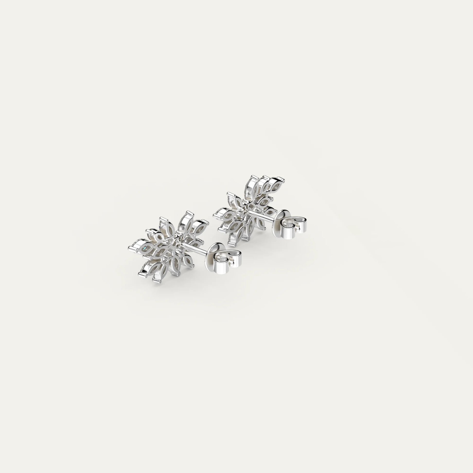 Close-up on Fleur Spark earrings by Goldmacher – floral-shaped sterling silver studs with zircons.