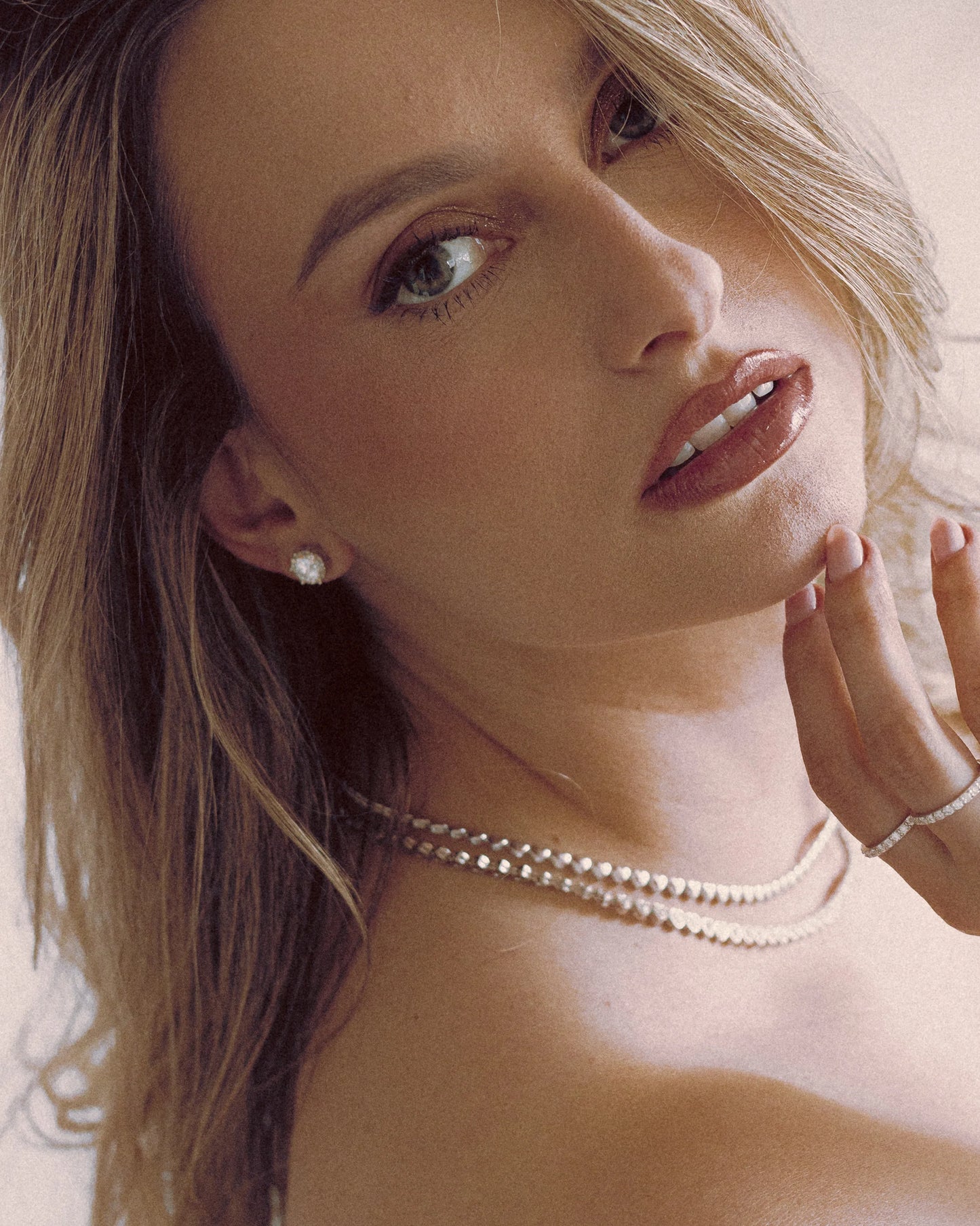 Model showcasing Goldmacher moissanite stud earrings