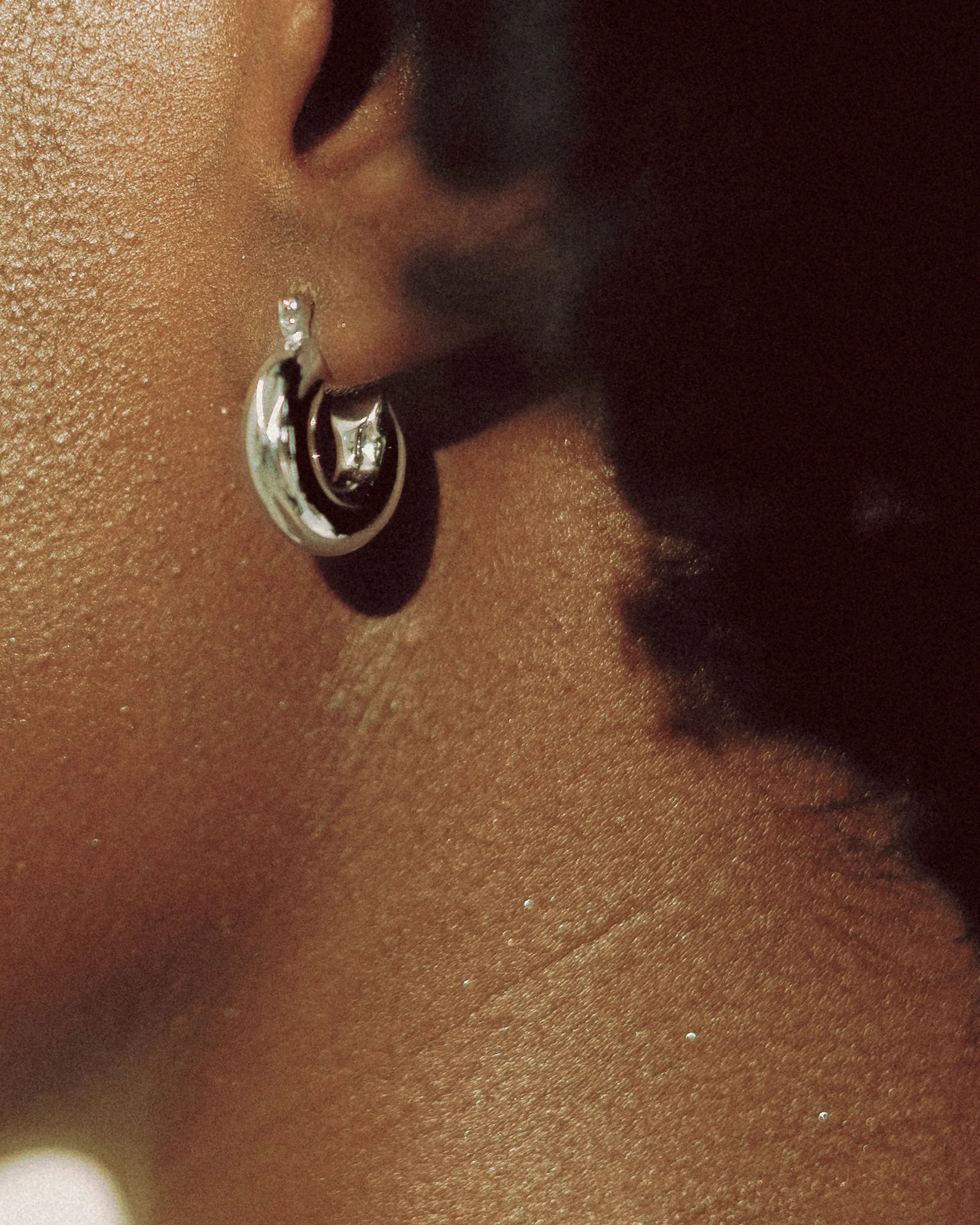Petite Dome Hoop Earrings by Goldmacher – Sculptural small hoops styled on model for modern everyday wear