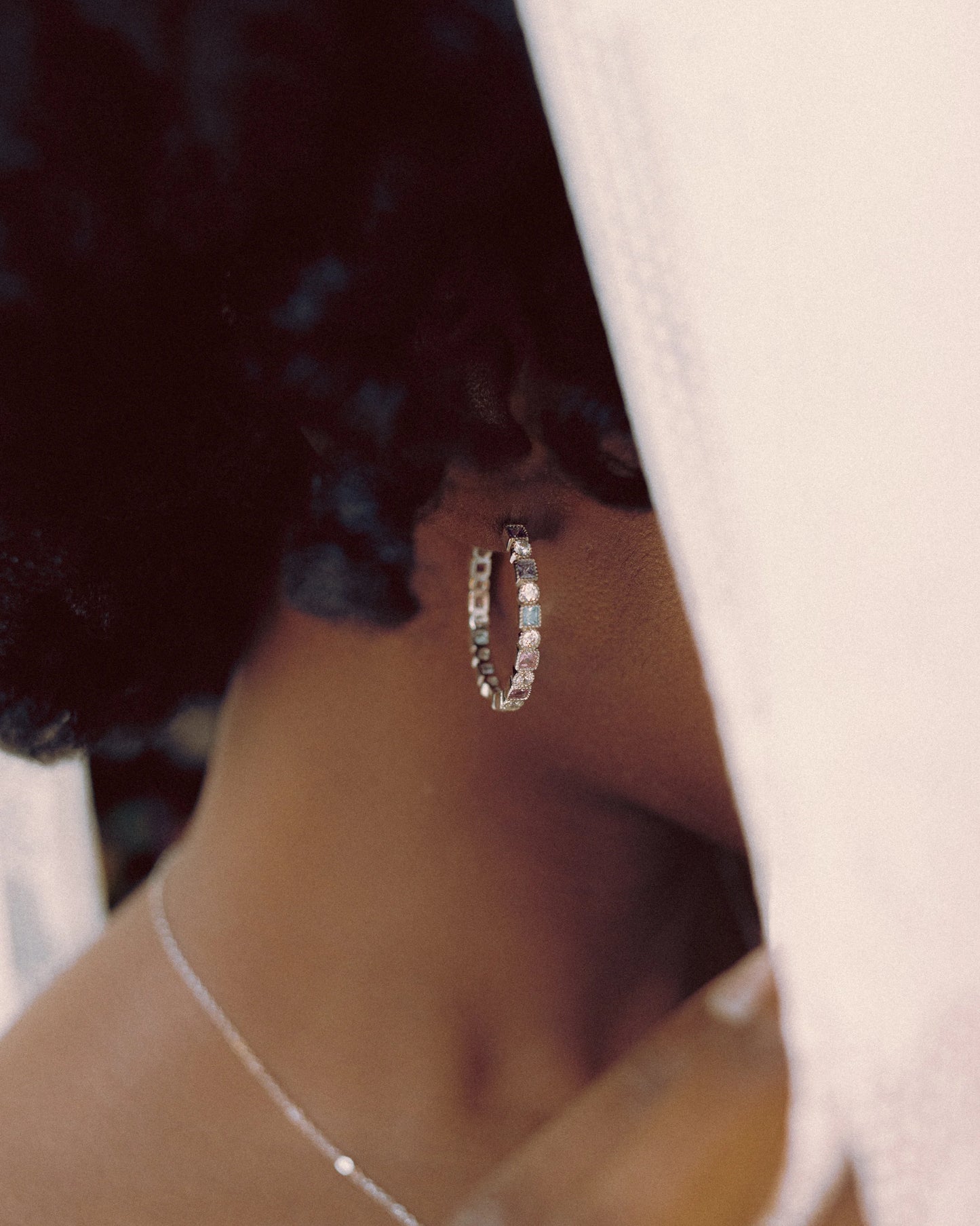 Prism Loop Earrings by Goldmacher – Colorful zircon hoops in 925 silver shown in close-up on model