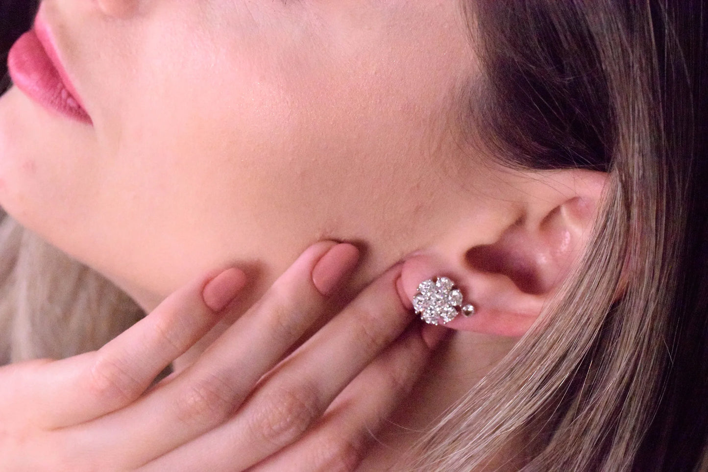 Model wearing Goldmacher Calytrix silver moissanite floral cluster earrings