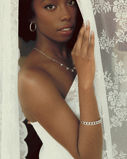 Model wearing Goldmacher Cuban Link Bracelet in silver with everyday minimal styling
