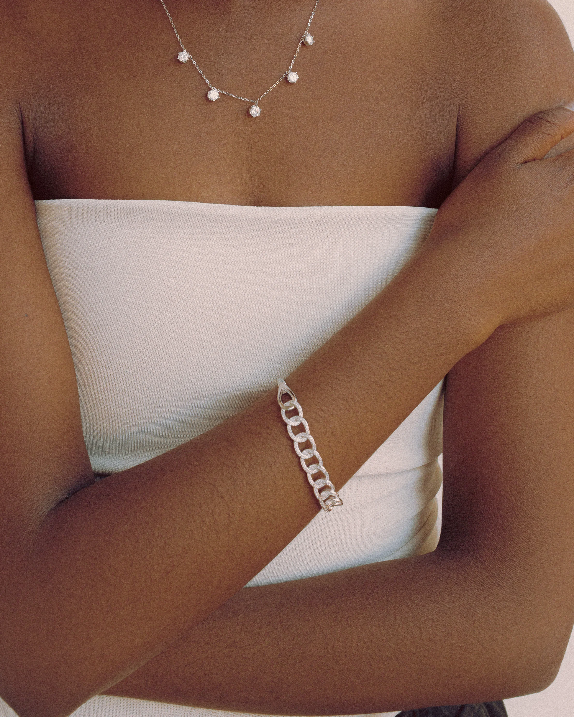 Fashion-forward look featuring Goldmacher Cuban Link Bracelet styled with layered necklace