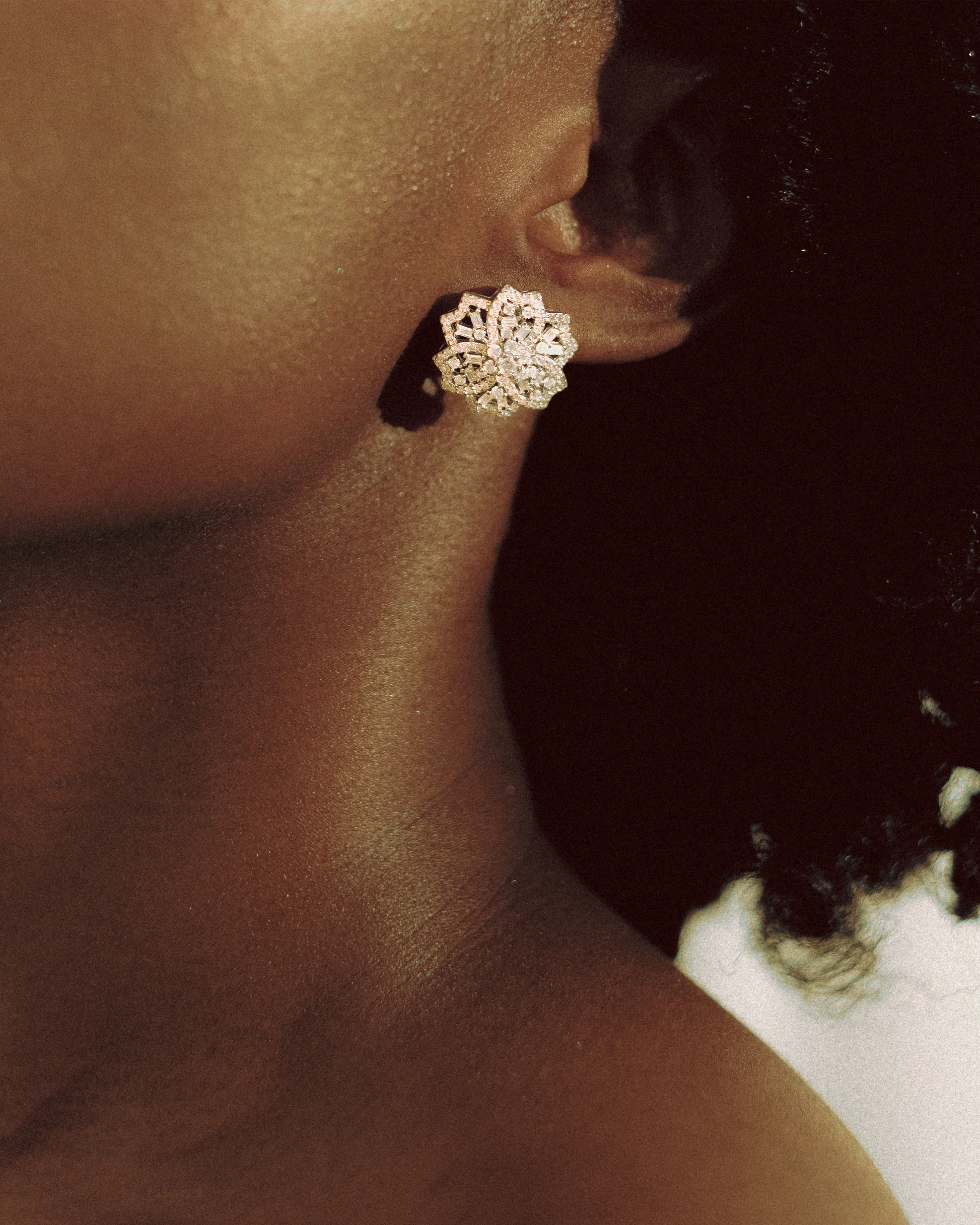  Styled lifestyle shot of Goldmacher moissanite floral earrings worn by model