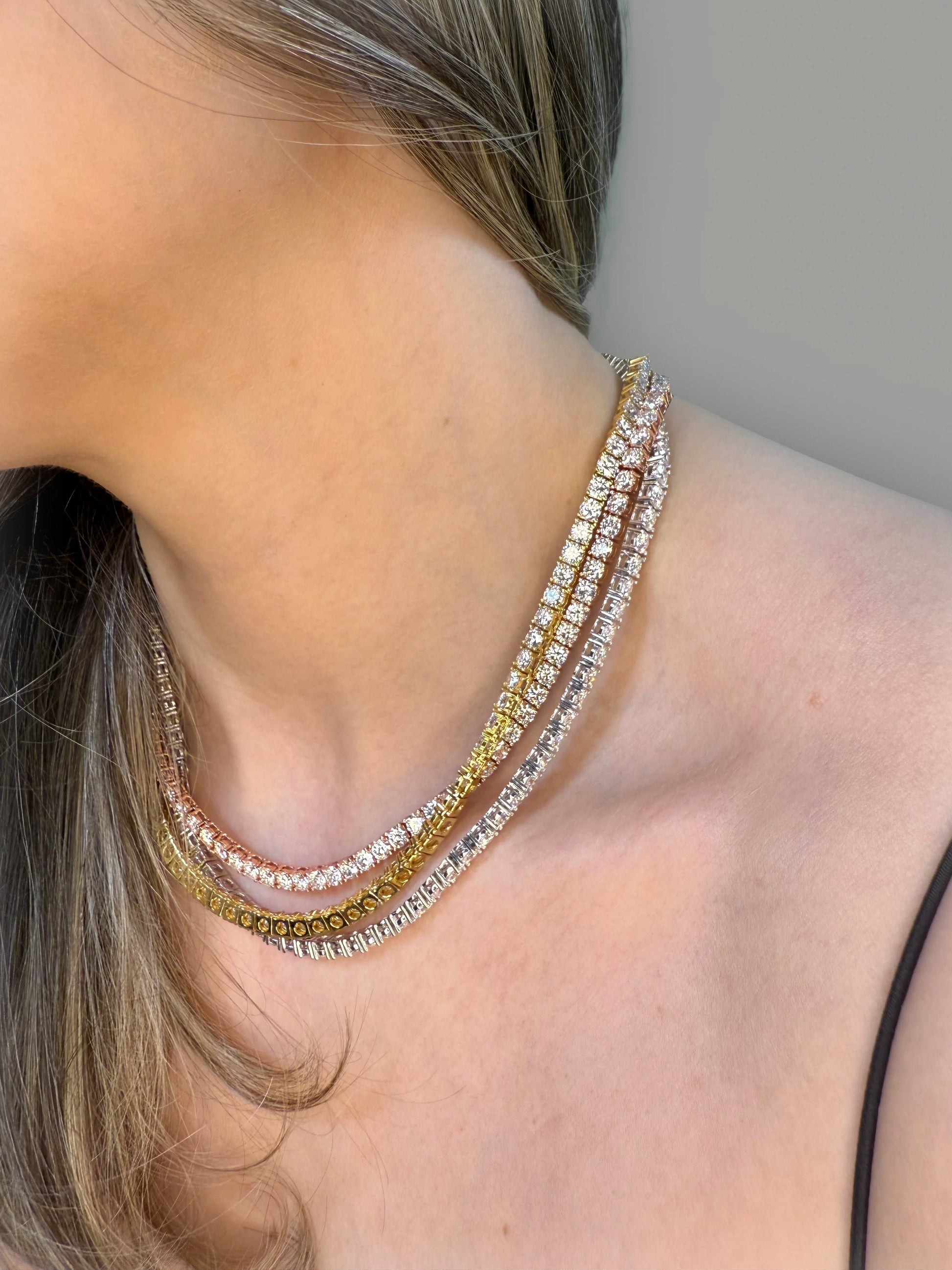 Minimalist styling showcasing Goldmacher moissanite tennis chain in gold rose and silver