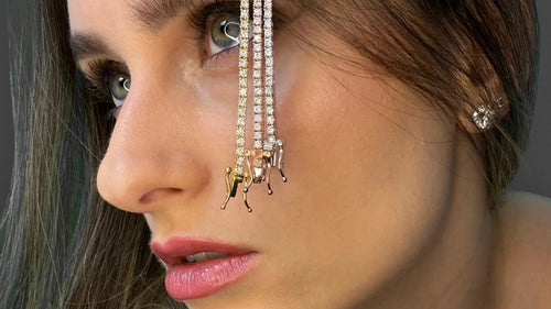 Side profile view highlighting the Goldmacher moissanite stud earrings and tennis chain