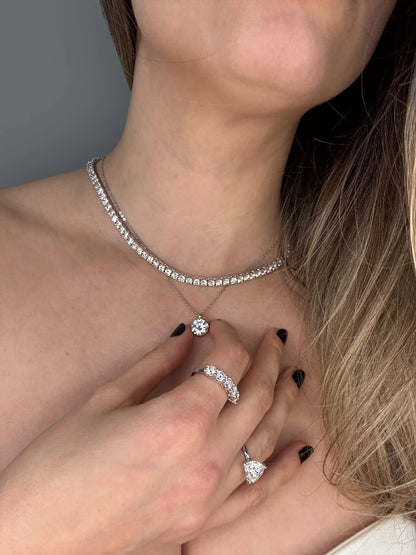 Model showcases Goldmacher moissanite tennis necklace and heart solitaire studs 2