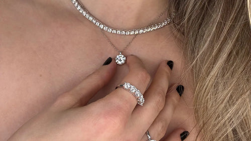 Stylish combination: the model showcases Goldmacher moissanite tennis necklace and heart solitaire studs