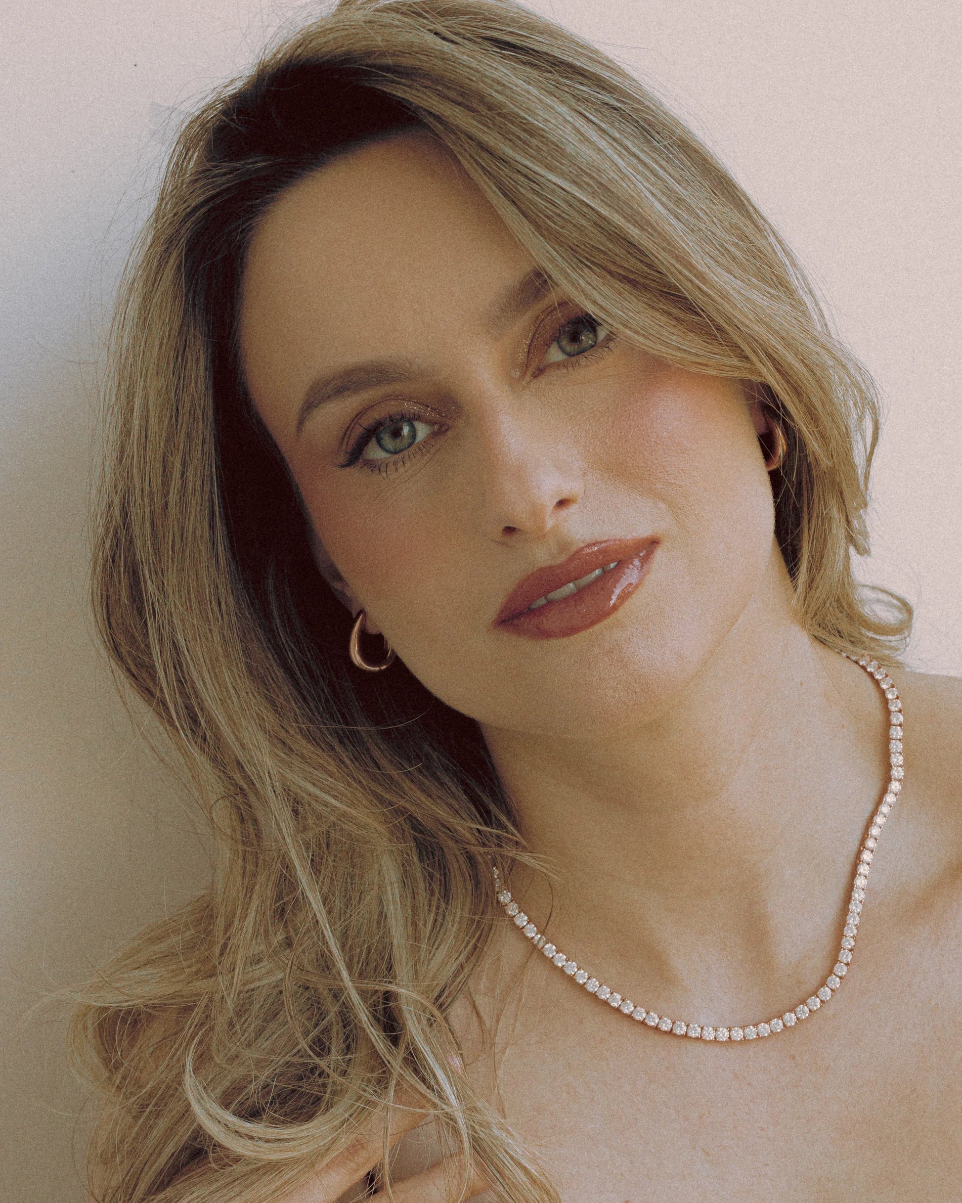 Molten Hoops Earrings by Goldmacher – Sculptural fluid-shaped hoops shown on model for an elegant statement look