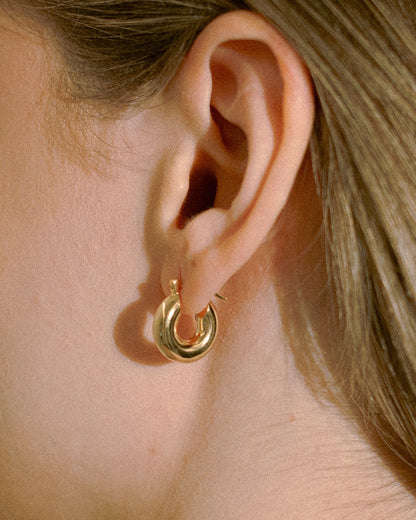 Goldmacher Petite Dome Hoops – Minimalist domed hoop earrings shown worn by model in close-up detail