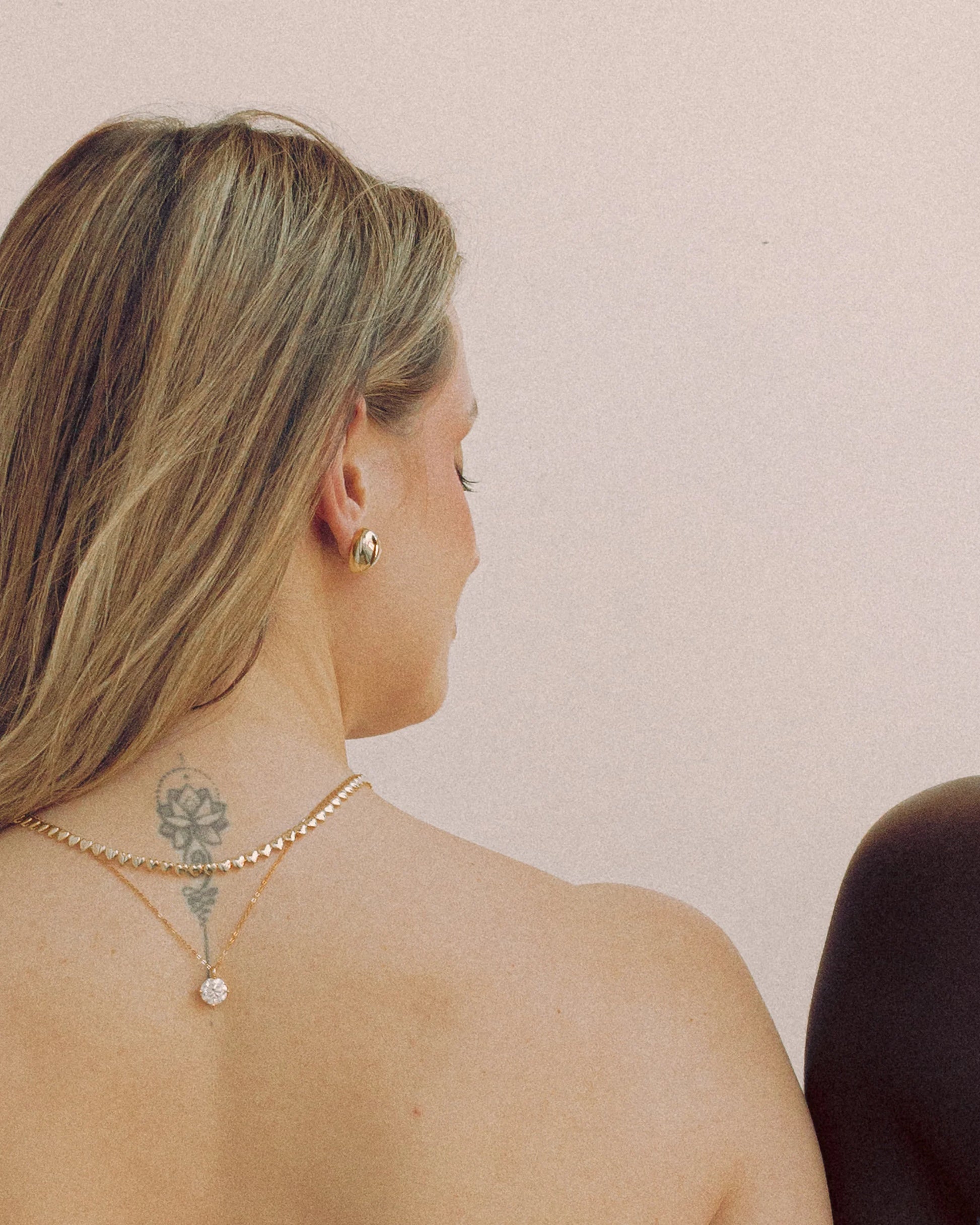 Puffy Heart Earrings by Goldmacher – Polished heart-shaped earrings styled on ear for a playful, modern look